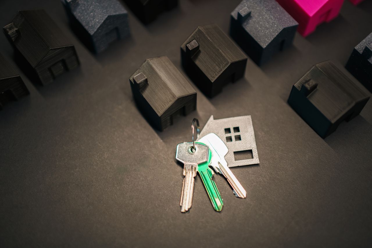 home-hero-bg Miniature house models and keys symbolize real estate investment and housing market.